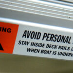 Pontoon boat deck rail and gate warning at 2013 Tulsa Boat Show.